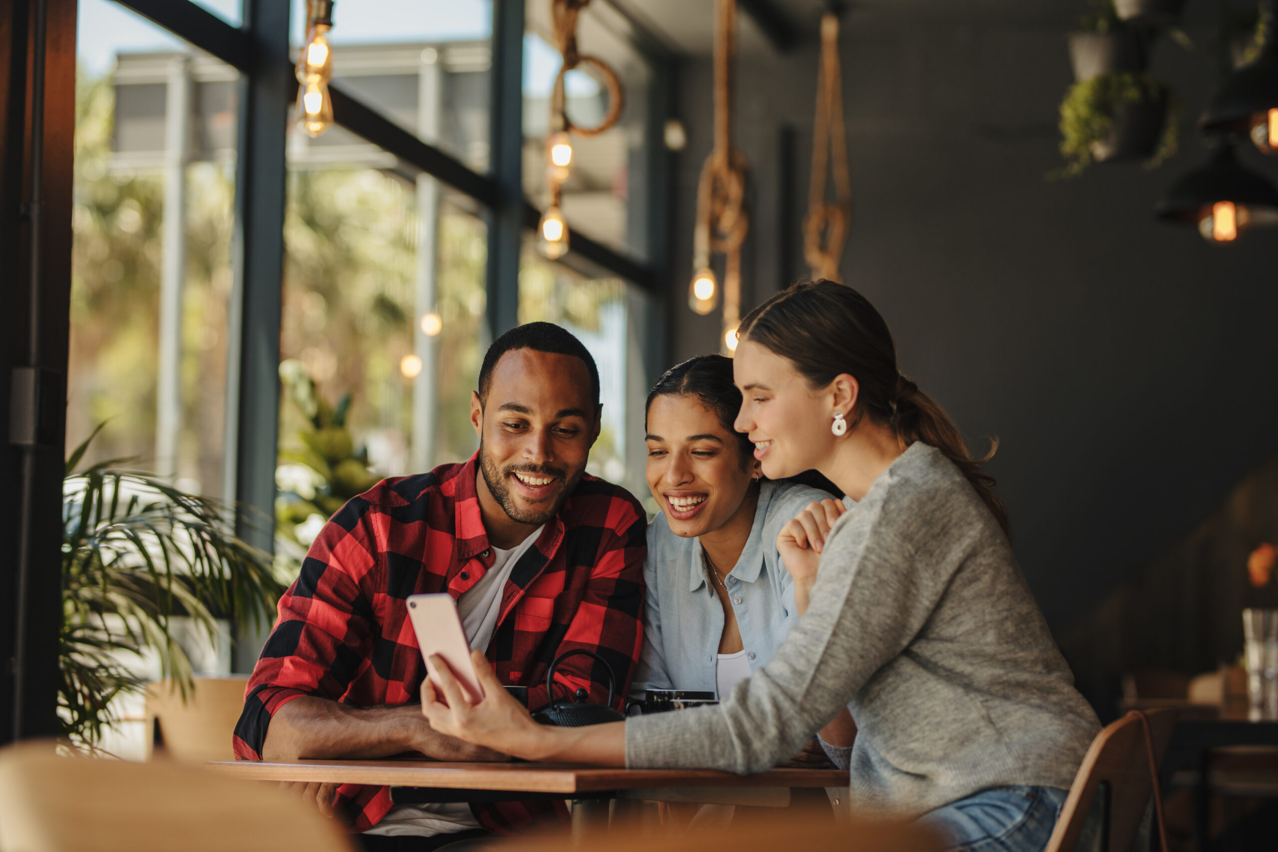 Intended parents and surrogate meeting at a coffee shop to share and discuss their fertility journey.